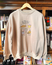 A light beige crewneck sweatshirt with a 'Fall Bucket List' embroidered print.