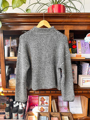 the back of a black and white striped sweater.